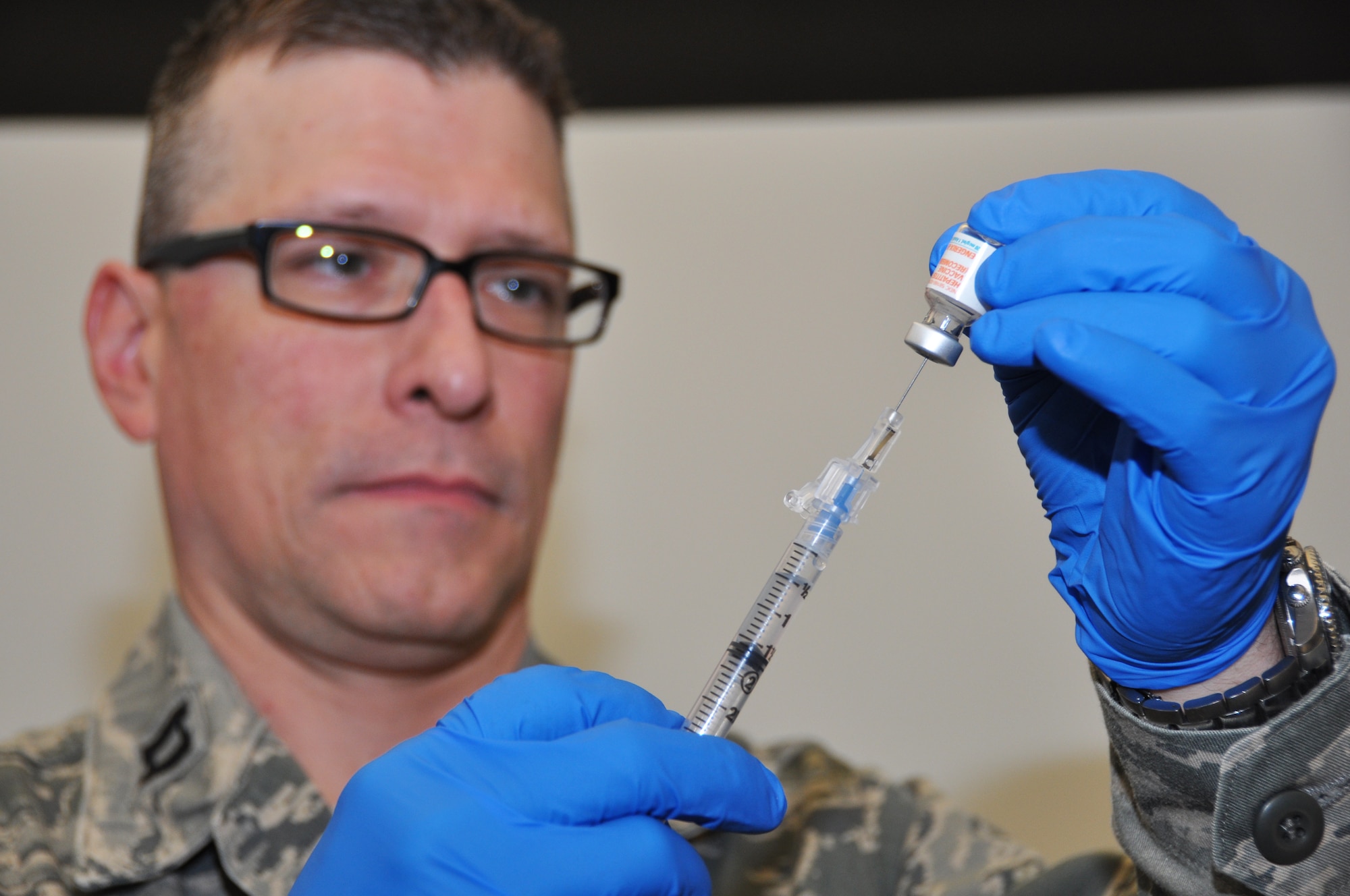 Capt. Mark Burkard prepares a hepatitis B shot for injection here, April 5, 2014. The hepatitis B vaccine has recently been made mandatory for members who are or may be deploying in the near future. (U.S. Air Force photo by Staff Sgt. Stephanie Clark)  