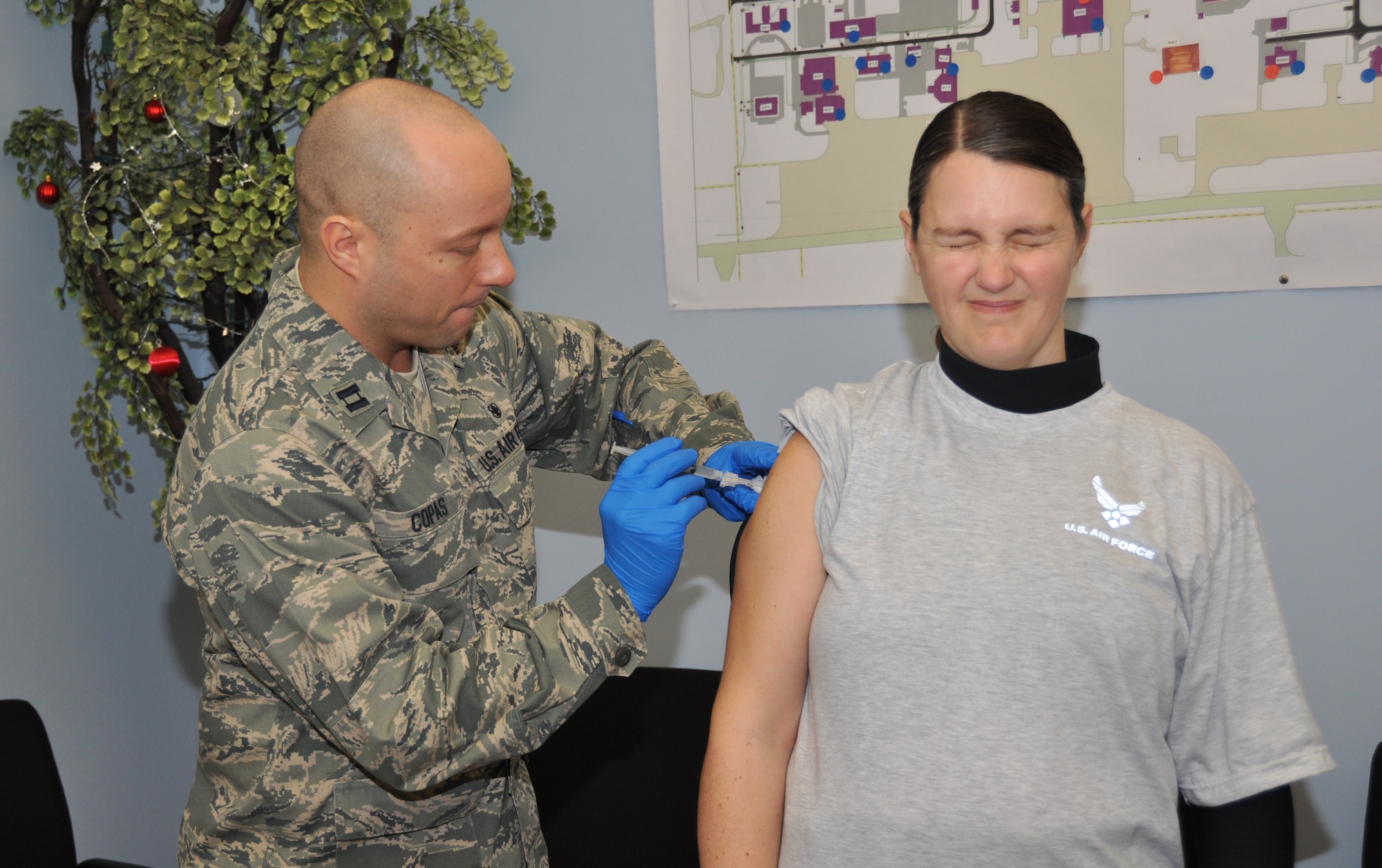 Master Sgt. Heather Jackson, 914th Communication Squadron, grimaces as Capt. John Copas, 914th Aeromedical Staging Squadron, administers the hepatitis B shot, here, April 5, 2014. The hepatitis B vaccine has recently been made mandatory for members who are or may be deploying in the near future. (U.S. Air Force photo by Staff Sgt. Stephanie Clark)  