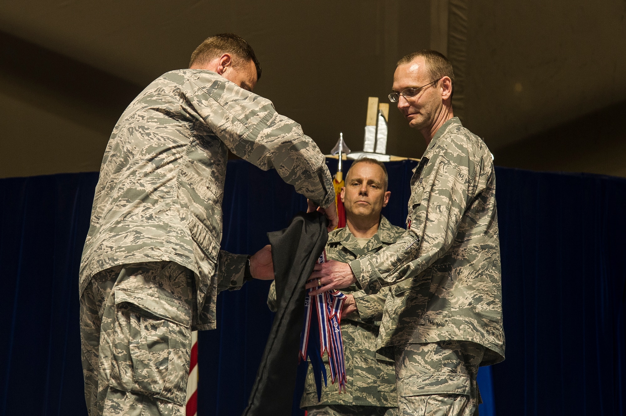 Col. John Millard, 376th Air Expeditionary Wing commander, sheathes the 376th Expeditionary Medical Group guide-on with Col. James Knowles, 376th EMDG commander, during the group’s inactivation ceremony at Transit Center at Manas, Kyrgyzstan, April 05, 2014. The 376th EMDG provided routine, urgent and emergency care to anyone who walked through their doors. The history of the 376th EMDG dates back to May 1951, when it was constituted as the 376th Medical Squadron. The 376th EMDG of today received its re-designation and activation on Dec. 4, 2001. (U.S. Air Force photo/Senior Airman George Goslin)


