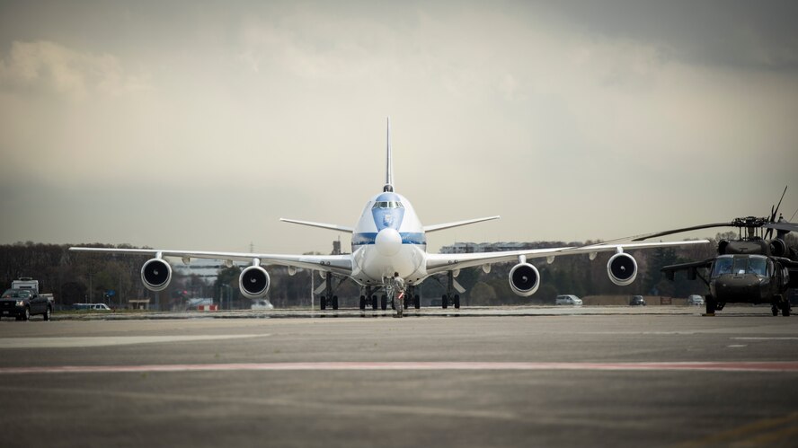 An Airman from the 374th Maintenance Squadron marshals the National Airborne Operation Center carrying U.S. Secretary of Defense Chuck Hagel at Yokota Air Base, Japan, April 5, 2014. Hagel visited Yokota during his fourth visit to the Asia-Pacific region, which includes stops in Hawaii, Japan, China and Mongolia. (U.S. Air Force photo by Capt. Raymond Geoffroy)