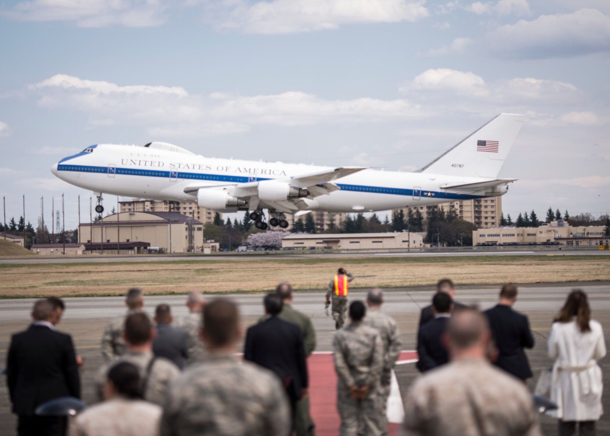 Leaders stand-by as the National Airborne Operation Center carrying U.S. Secretary of Defense Chuck Hagel lands at Yokota Air Base, Japan, April 5, 2014. Hagel visited Yokota during his fourth visit to the Asia-Pacific region, which includes stops in Hawaii, Japan, China and Mongolia. (U.S. Air Force photo by Capt. Raymond Geoffroy)