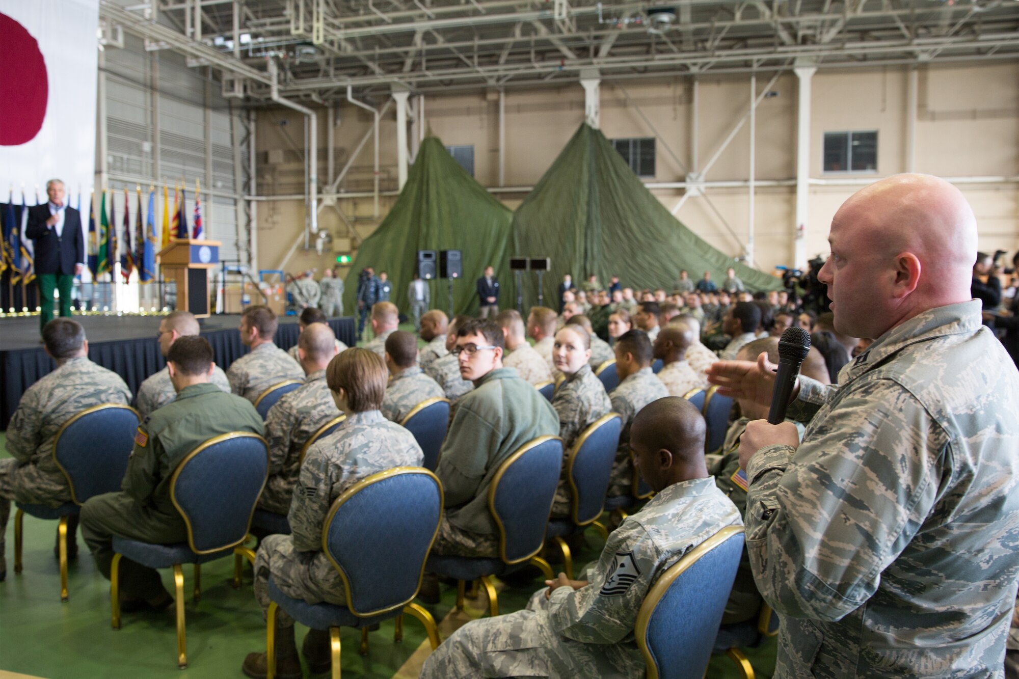Capt. Wayne Gutman, 374th Medical Support Squadron, asks U.S. Secretary of Defense Chuck Hagel a question during a troop call event at Yokota Air Base, Japan, April 5, 2014. Hagel visited Yokota during his fourth official visit to the Asia-Pacific region, which includes stops in Hawaii, Japan, China and Mongolia. (U.S. Air Force photo by Osakabe Yasuo/Released)
