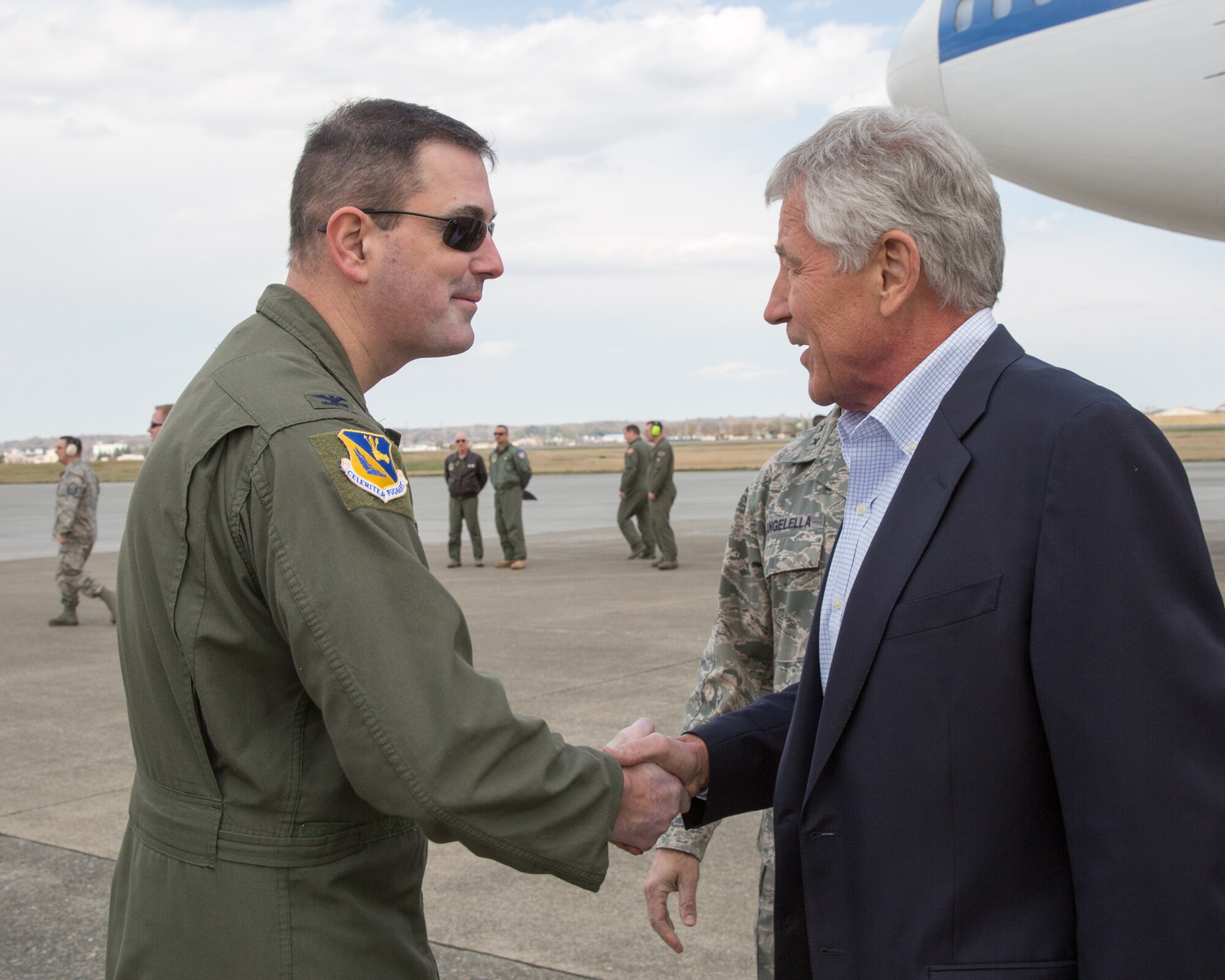Col. Mark August, 374th Airlift Wing commander, greets U.S. Secretary of Defense Chuck Hagel upon his arrival at Yokota Air Base, Japan, April 5, 2014.  Hagel visited Yokota during his fourth official visit to the Asia-Pacific region, which includes stops in Hawaii, Japan, China and Mongolia. (U.S. Air Force photo by Osakabe Yasuo/Released)