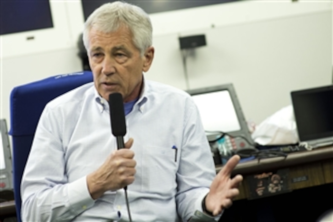 U.S. Defense Secretary Chuck Hagel briefs reporters while en route to Tokyo, April 4, 2014. Hagel was traveling from Honolulu, where he hosted a forum for defense ministers from the Association of South East Asian Nations.