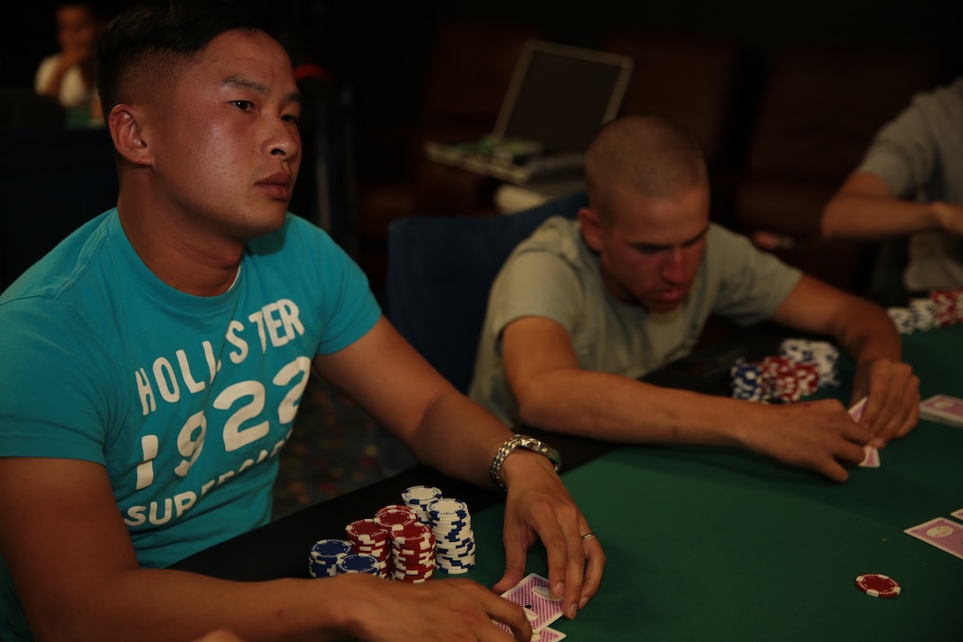 Sgt. Phong Khai Che, food serveice specialist, Headquarters Battalion, stares at a player across the table during the Texas Hold’em Poker Tournament hosted by the Single Marine Program at The 5th Street Zone, March 28, 2014. Along with newcomers, seasoned veterans saw the entertainment in the event, even with years of experience in card games.


