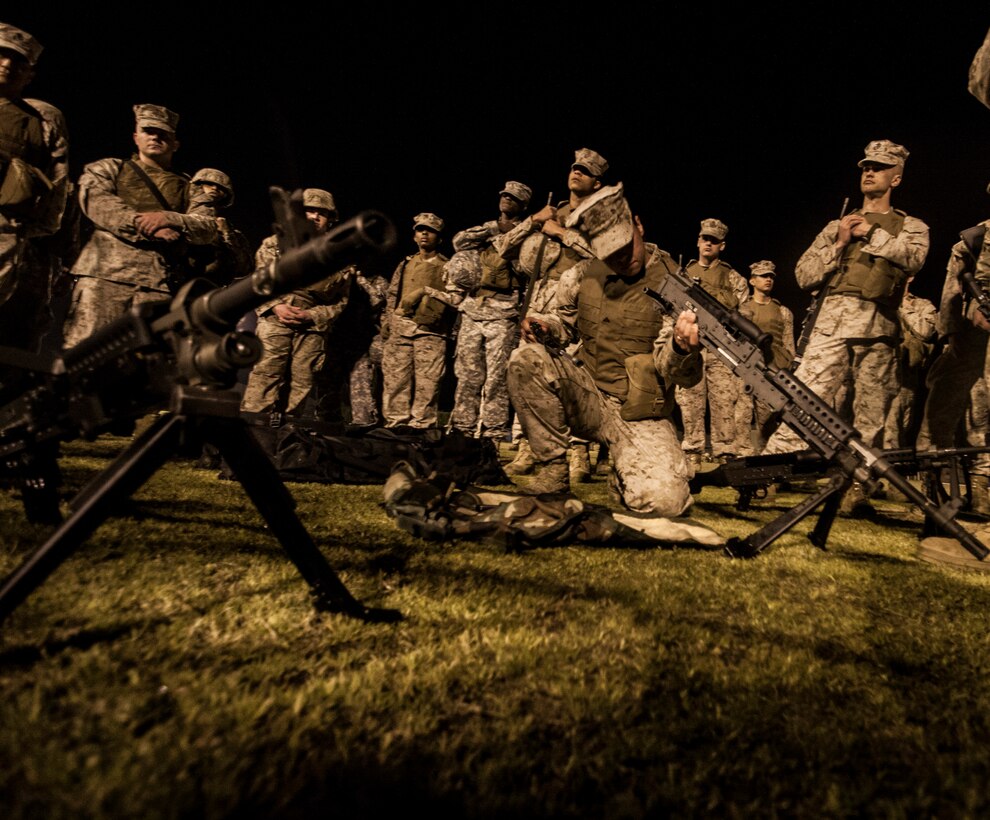 Lance Cpl. Kristen K. Kahalewai, a participant in the Headquarters and Headquarters Squadron bivouac and hike exercise, reassembles an M240B at Penny Lake Field aboard Marine Corps Air Station Iwakuni, Japan, March 27 - 28, 2014. The evolution gave members of the squadron a chance to practice patrolling techniques, re-familiarize themselves with crew-served weapons and learn call-to-fire procedures. Participants awoke early the day after the bivouac to conduct a 10-kilometer hike in fire teams, ending with a warrior's breakfast at the southside chowhall.
