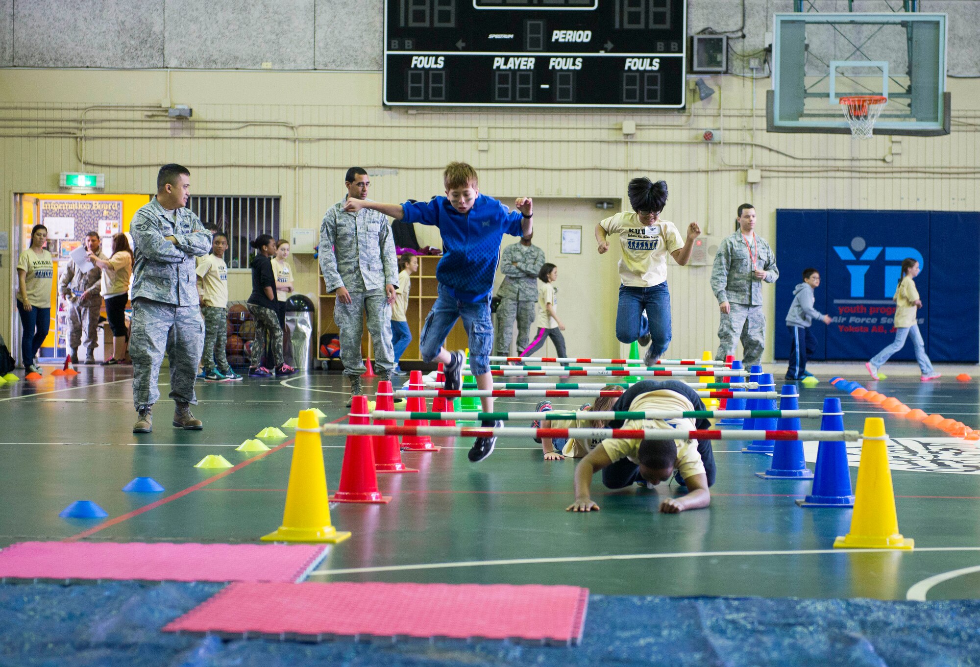 Children participate in an obstacle course during the Kids Understanding Deployment Operations Support program April 4, 2014 at Yokota Air Base, Japan. During KUDOS, children were able to participate in many events including weapons and supply demonstrations and combat face painting. (U.S. Air Force photo by Staff Sgt. Chad C. Strohmeyer/Released)