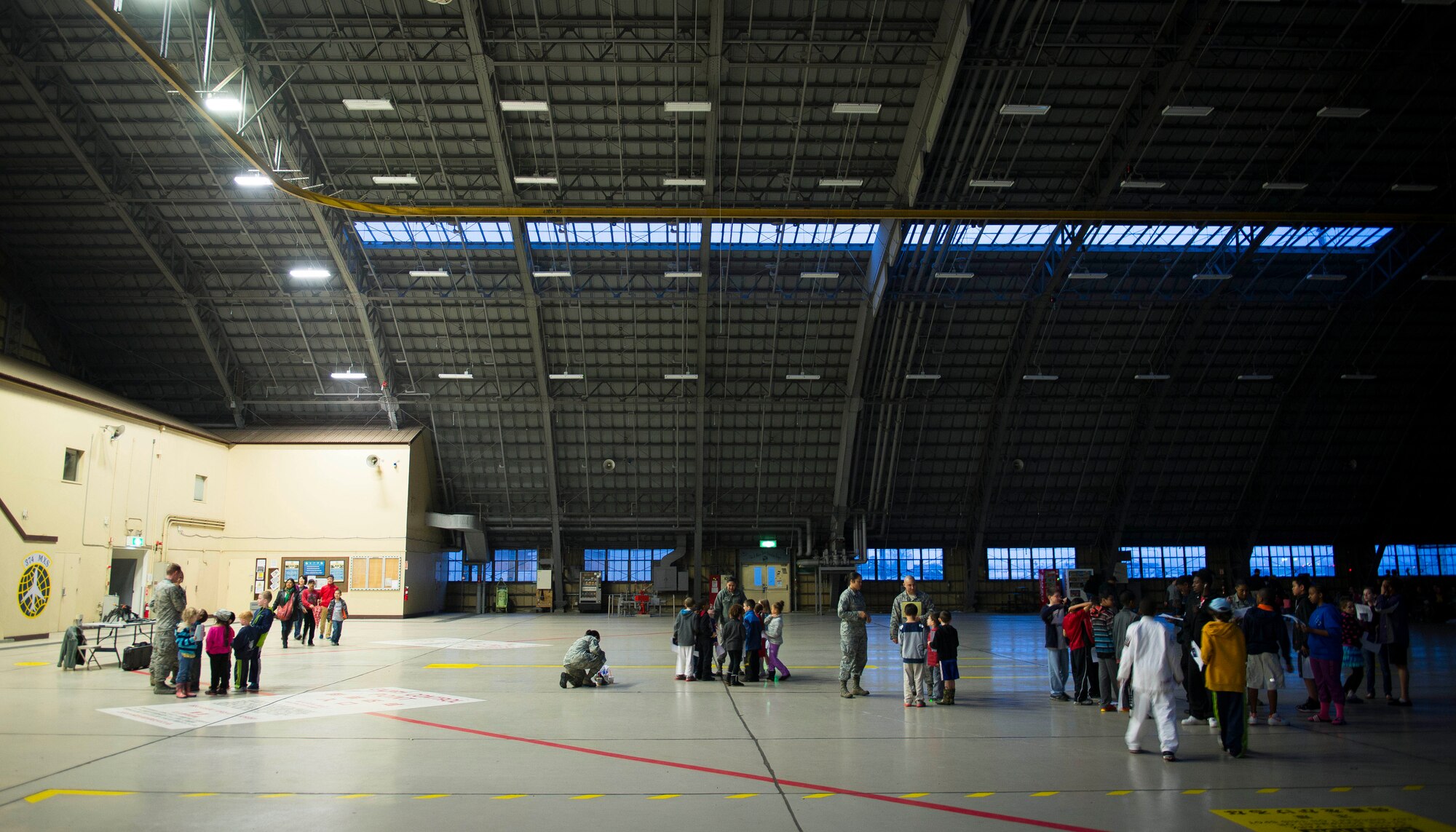 Children find their respective chalk assignments during initial orientation as part of the Kids Understanding Deployment Operations Support program on day one April 3, 2014 at Yokota Air Base, Japan. KUDOS allows children to experience the deployment process and gain insight into how their parents live and work while deployed. (U.S. Air Force photo by Staff Sgt. Chad C. Strohmeyer/Released)