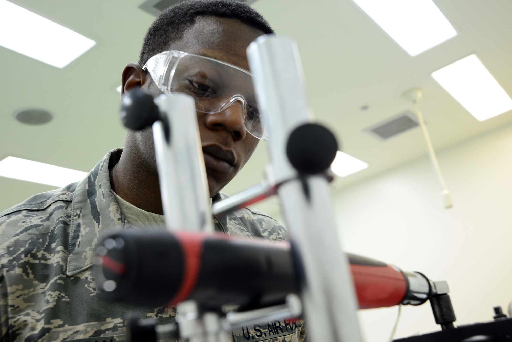 Airman 1st Class DeSean Freeman, 35th Maintenance Squadron, calibrates a torque wrench at Misawa Air Base, Japan, March 28, 2014. Freeman specializes in physical and dimensional measurements, which is one of three sections within to the Precision Measurement Equipment Laboratory here. (U.S. Air Force photo/Senior Airman Derek VanHorn)