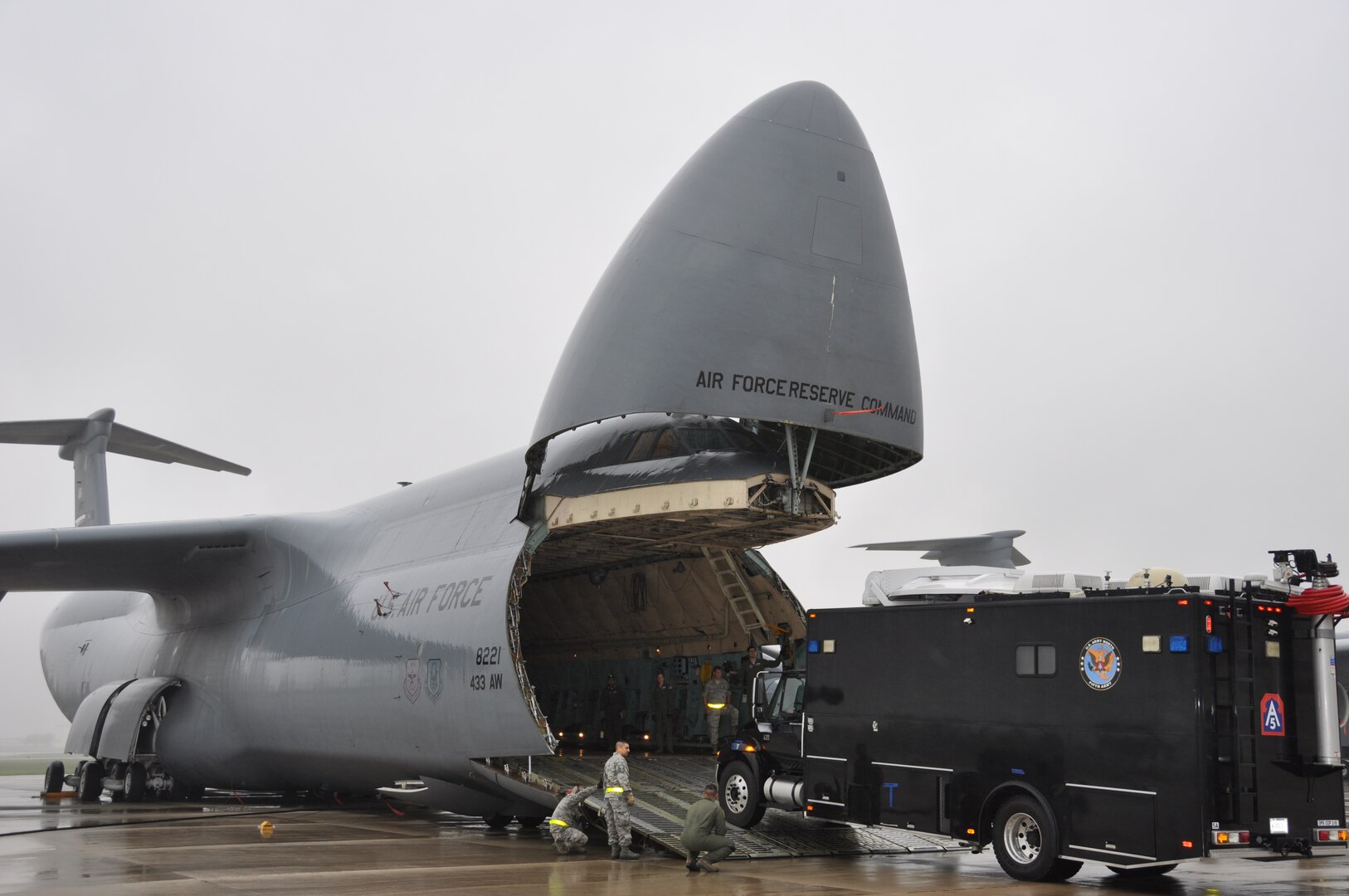 "The Sentinel", a command, communications and control vehicle from Joint Base San Antonio-Ft. Sam Houston’s Army North’s Task Force-51, drives onto a C-5A Galaxy under the guidance of loadmasters form the 68th Airlift Squadron on April 6, 2014. The top of the vehicle cleared the C-5A Galaxy’s upper deck by five inches.  (U.S. Air Force photo by Tech Sgt. Carlos J. Trevino)
