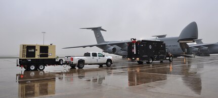 A convoy from Joint Base San Antonio-Ft. Sam Houston’s Army North’s Task Force-51 drives onto a C-5A Galaxy on April 6, 2014. The exercise provided Air Force Reservists and active duty Soldiers an opportunity to load and offload Task Force-51’s vehicles onto a C-5A Galaxy.   (U.S. Air Force photo by Tech Sgt. Carlos J. Trevino)