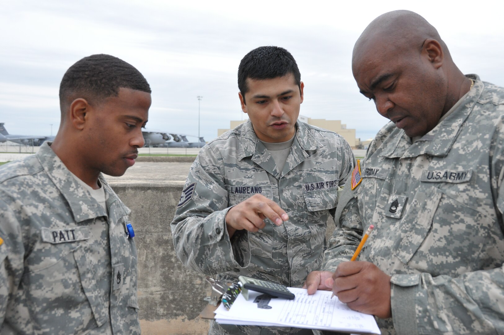 Staff Sgt. Joseph Patt, an Army North Task Force-51 communications noncommissioned officer, listens as Staff Sgt. Julio Laureano (center), a 74th Aerial Port Squadron air transportation special handler, explains to Sgt. 1st Class Friday Steadman, an Army North Task Force-51 mobility NCO, how to solve a problem when weighing a vehicle to be up loaded to a C-5A Galaxy aircraft on April 5, 2014 at Joint Base San Antonio-Lackland, Texas.  Task Force-51 from Joint Base San Antonio-Ft. Sam Houston, mission is responding to hazards and incidents in the United States that require Department of Defense assistance. (U.S. Air Force photo by Tech Sgt. Carlos J. Trevino)