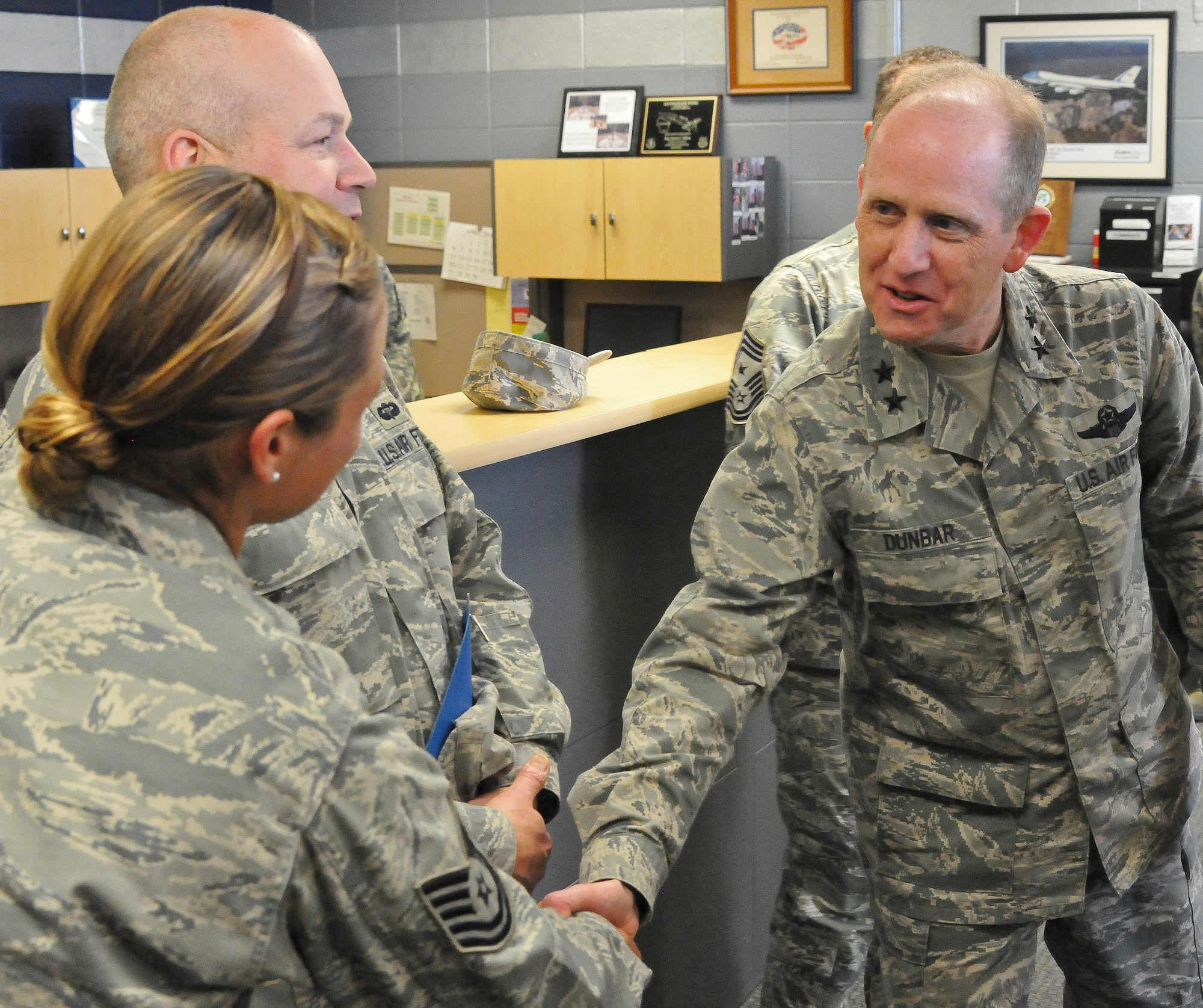 Maj. Gen. Donald P. Dunbar, the adjutant general of Wisconsin greets Tech. Sgt. Kitrina Vargas of the 128th Air Refueling Wing Small Air Terminal, Milwaukee, on a planned tour during the unit training assembly April 6, 2014.
