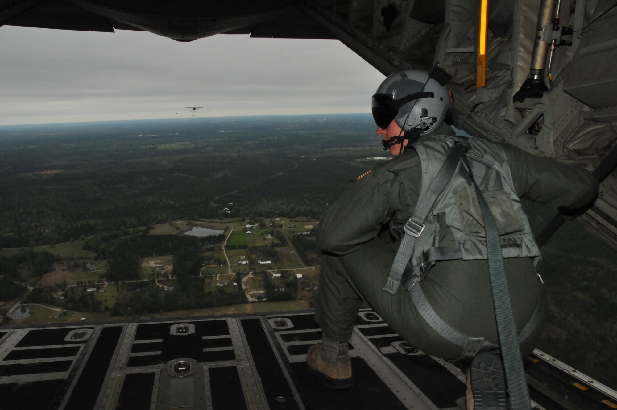 Senior Airman Brandon Price, an 815th Airlift Squadron loadmaster, prepares for the simulated cargo drop while participating in Operation Surge Capacity here April, 5, 2014.  Sixteen aircraft from the 403rd Wing took part in Operation Surge Capacity, a large scale training exercise designed to test the 403rd Wing's ability to launch and recover a large formation of aircraft and to execute airdrops. (U.S. Air Force photo/ Senior Airman Nicholas Monteleone)
