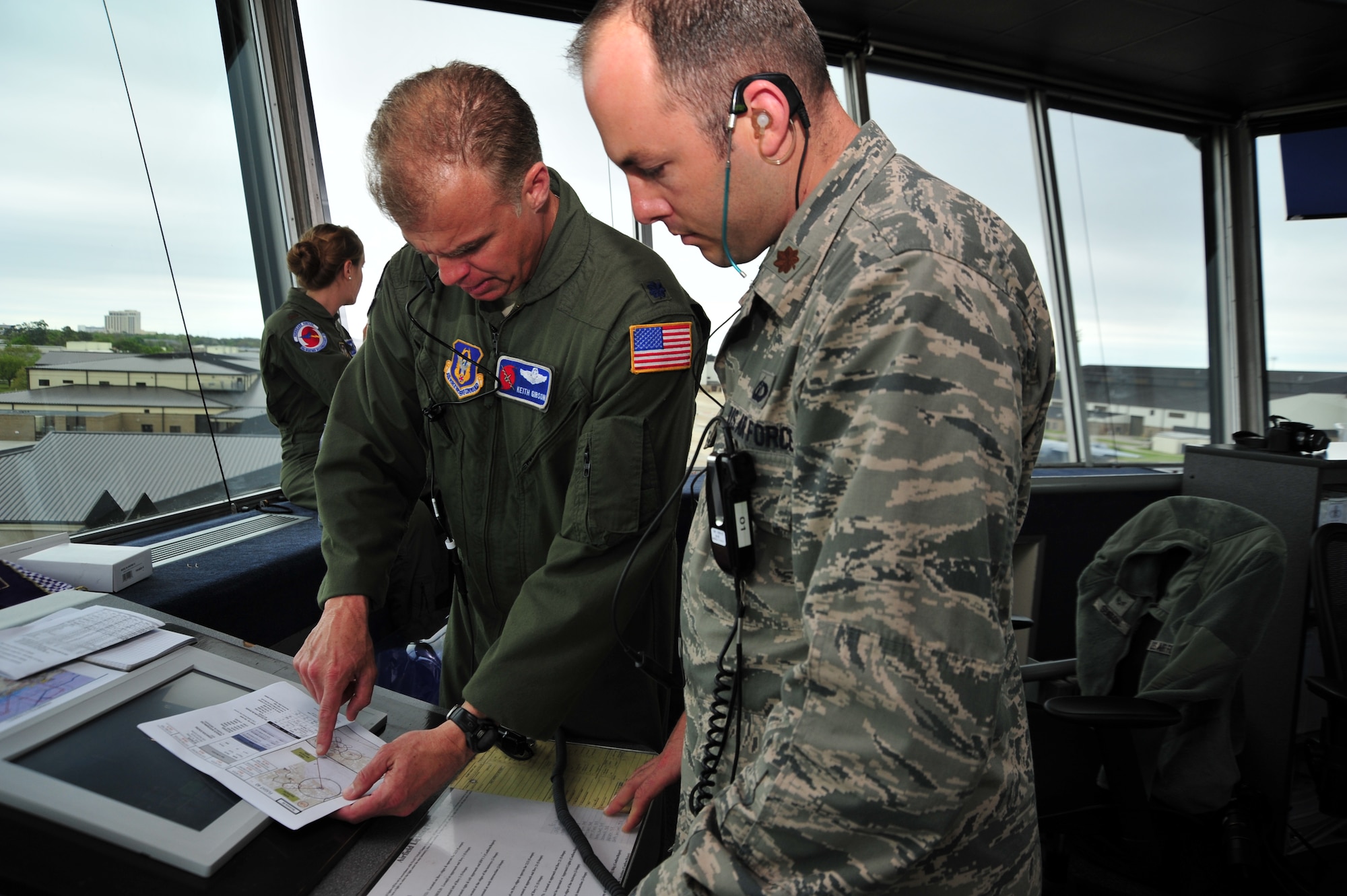 Lt. Col. Keith Gibson, 53rd Weather Reconnaissance Squadron director of operations, and Maj. Josh Pitler, 81st Operation Support Flight commander, review the flight path for aircraft from the 403rd Wing here April 5, 2014.  Sixteen aircraft from the 403rd Wing took part in Operation Surge Capacity, a large scale training exercise designed to test the 403rd Wing's ability to launch and recover a large formation of aircraft and to execute airdrops. (U.S. Air Force photo/Tech. Sgt. Ryan Labadens)