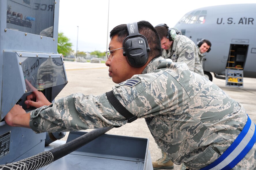 Senior Airman Kristian Pasion, 403rd Aircraft Maintenance Squadron aerospace journeyman, checks a -86 external power generator providing power to a C-130J aircraft from the 815th Airlift Squadron here April 5, 2014.  Sixteen aircraft from the 403rd Wing took part in Operation Surge Capacity, a large scale training exercise designed to test the 403rd Wing's ability to launch and recover a large formation of aircraft and to execute airdrops. (U.S. Air Force photo/Tech. Sgt. Ryan Labadens)