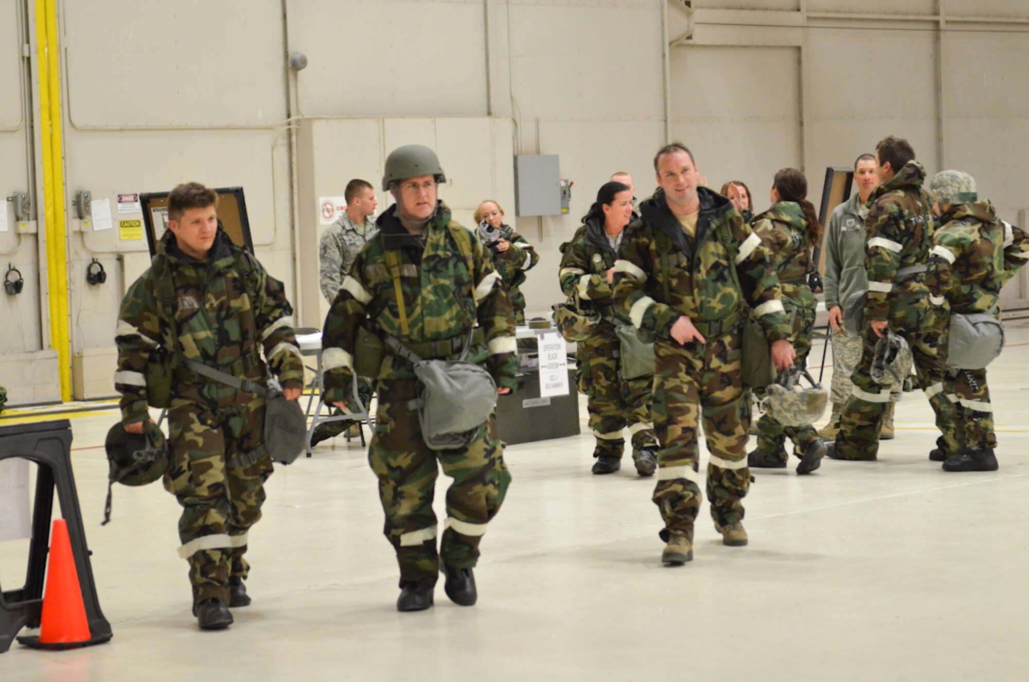 U.S. Air Force Airmen depart the training area after an Ability to Survive and Operate (ATSO) exercise at Rosecrans Air National Guard Base, Mo., Apr. 4, 2014.  The ATSO exercise gave Airmen the opportunity to practice how to correctly don their protective uniform, describe an attack scene to authorities, and move from a contaminated zone to a clean zone. (U.S. Air National Guard photo by Tech. Sgt. Theo Ramsey/Released)