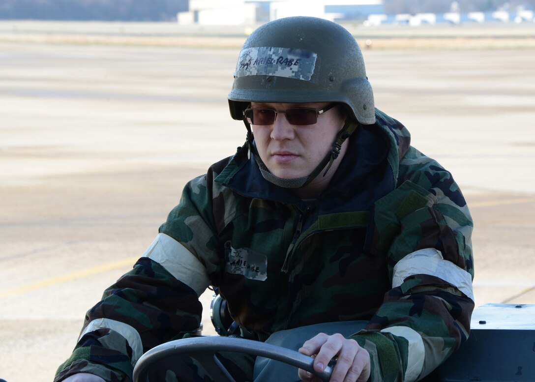 U.S. Air Force Staff Sgt. Ari Rabe, an avionics mechanic assigned to the 175th Aircraft Maintenance Squadron, Maryland Air National Guard, guides a targeting pod (TGP) to an A-10C Thunderbolt during a Phase II Chemical Warfare Exercise April 5, 2014 at Warfield Air National Guard Base, Baltimore, Md. (U.S. Air National Guard photo by Tech. Sgt. Christopher Schepers/RELEASED)