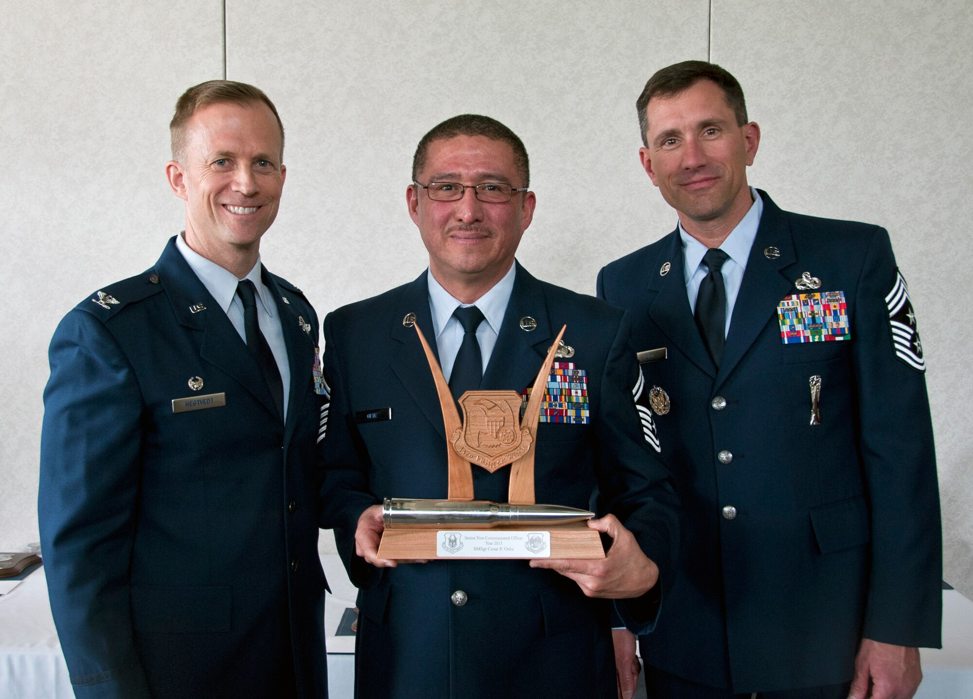 U.S. Air Force Col. Hubie Hegtvedt, 442nd Fighter Wing commander, and Chief Master Sgt. James Nudd, 442nd FW command chief, pose with Senior Master Sgt. Cesar Ortiz, 442nd Force Support Squadron, at the 442 FW annual awards luncheon at the Whiteman Air Force Base, Mo. Royal Oaks golf course April 6, 2014. Ortiz was awarded Senior NCO of the Year for 2013 at the awards ceremony. (U.S. Air Force photo by Senior Airman Daniel Phelps/Released)