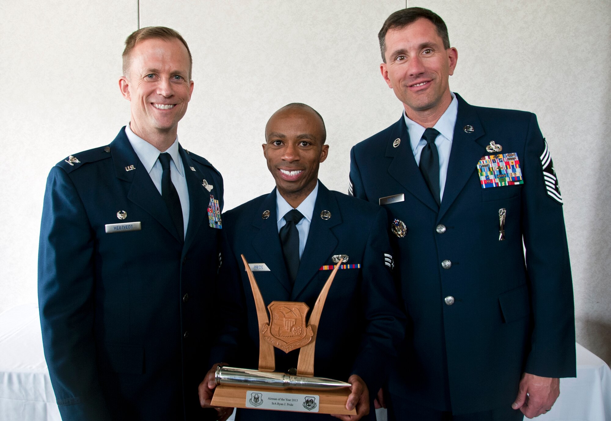U.S. Air Force Col. Hubie Hegtvedt, 442nd Fighter Wing commander, and Chief Master Sgt. James Nudd, 442nd FW command chief, pose with Senior Airman Ryan Pride, 442nd Force Support Squadron, at the 442 FW annual awards luncheon at the Whiteman Air Force Base, Mo. Royal Oaks golf course April 6, 2014. Pride was awarded Airman of the Year for 2013 at the awards ceremony. (U.S. Air Force photo by Senior Airman Daniel Phelps/Released)