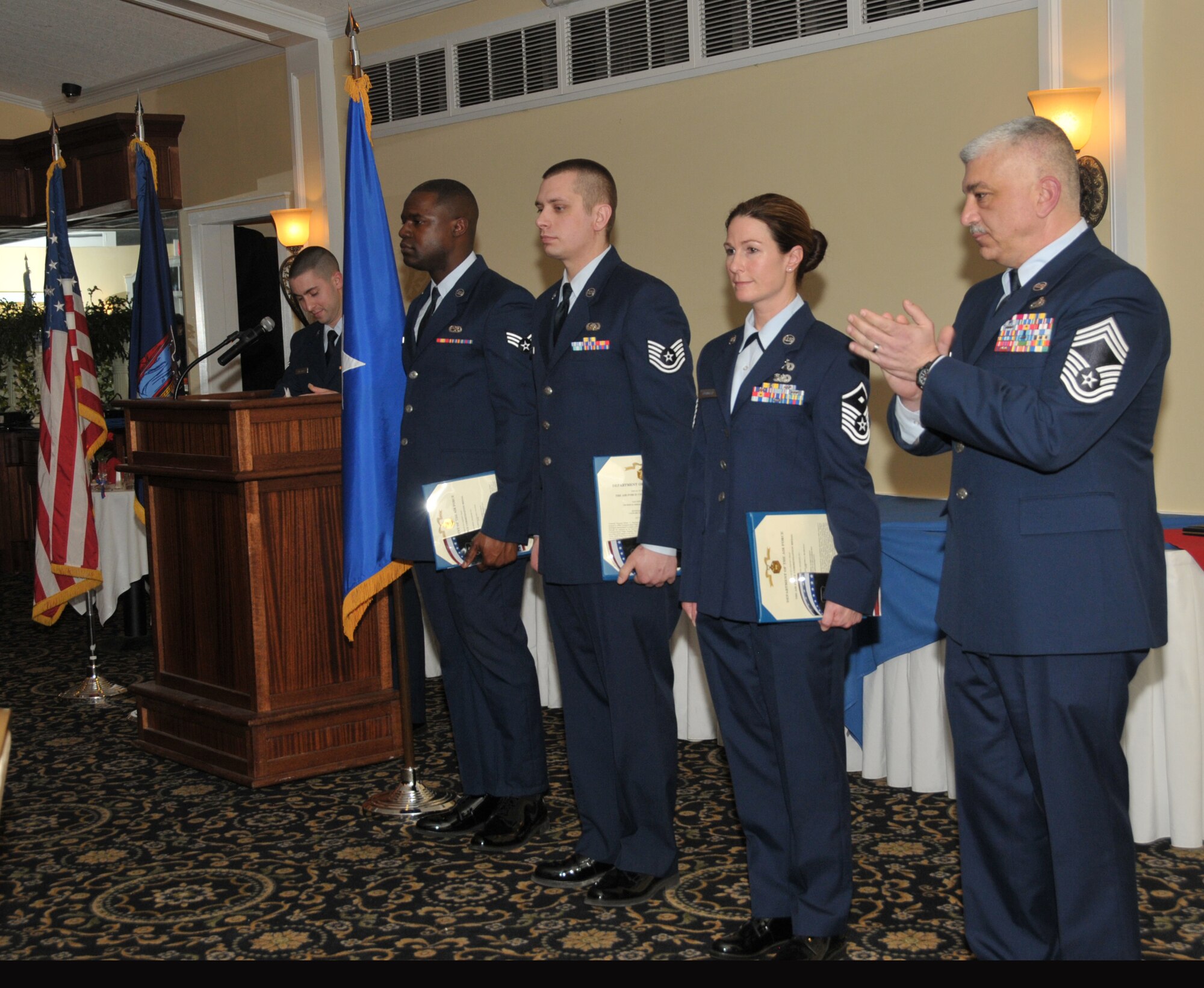 SCOTIA, N.Y. -- Senior Airman Kylief Tucker, Airman of the Year, Tech. Sgt. Robert Harrington, NCO of the Year, and Master Sgt. Amanda Blodgett, First Sergeant of the Year, were all honored during the 109th Airlift Wing's annual Airmen of the Year Dinner on April 4. Chief Master Sgt. Mark Mann (right) accepted the award for Senior Master Sgt. Patrick FitzGerald (not pictured), Senior NCO of the Year. Tucker is assigned to the 109th Maintenance Squadron, Harrington is assigned to the 109th Communications Flight, Blodgett is assigned to the 109th Logistics Readiness Squadron, and FitzGerald is assigned to the 109th Small Air Terminal. (Air National Guard photo by Master Sgt. William Gizara/Released) 