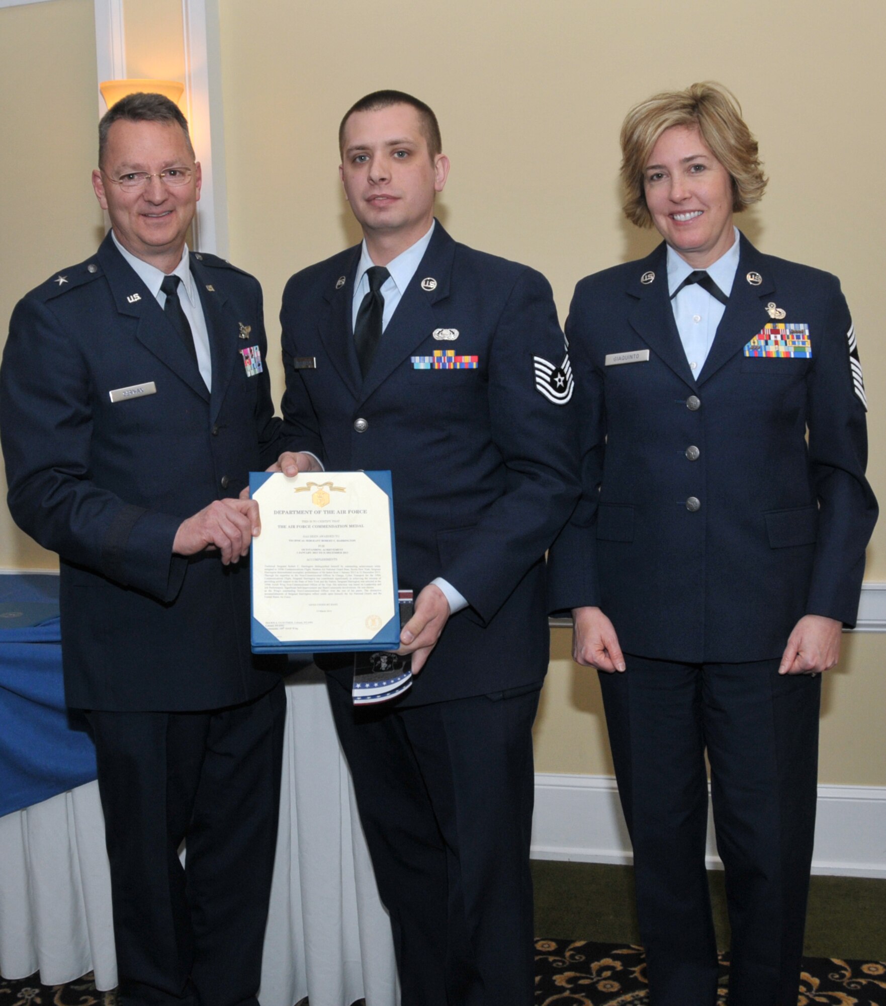SCOTIA, N.Y. -- Tech. Sgt. Robert Harrington, center, was named the 109th Airlift Wing's NCO of the Year. He was honored during the annual Airman of the Year Dinner on April 5. Also pictured are Brig. Gen. Anthony German, New York's Chief of Staff-Air, and Chief Master Sgt. Amy Giaquinto, 109th AW command chief.  Harrington is assigned to the 109th Communications Flight. (Air National Guard photo by Master Sgt. William Gizara/Released)