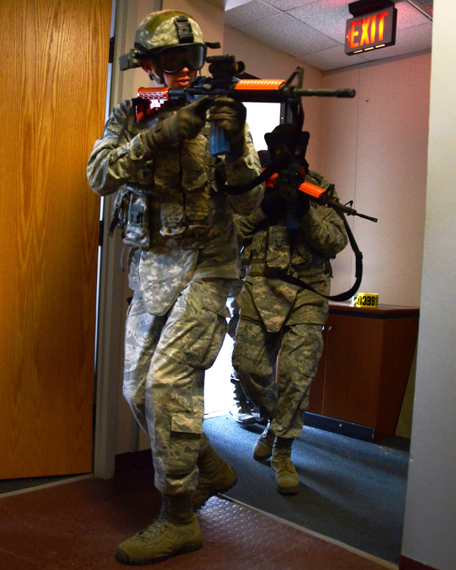 PEASE AIR NATIONAL GUARD BASE, N.H. -- U.S. Air Force Senior Airman Stephen Drown, front, and Senior Airman Riley Burley, 157th Security Forces Squadron, N.H. Air National Guard, enter a building during an active shooter training exercise at Pease Air Force Base April 5, 2014. The previously scheduled training comes just days after a gunman killed three people and injured 16 at Fort Hood in Texas. Active shooter events at military installations over the past several years have resulted in the Installation Exercise Program Office designing an active shooter scenario and integrating into the training schedule. (N.H. National Guard photo by Tech. Sgt. Mark Wyatt/RELEASED)