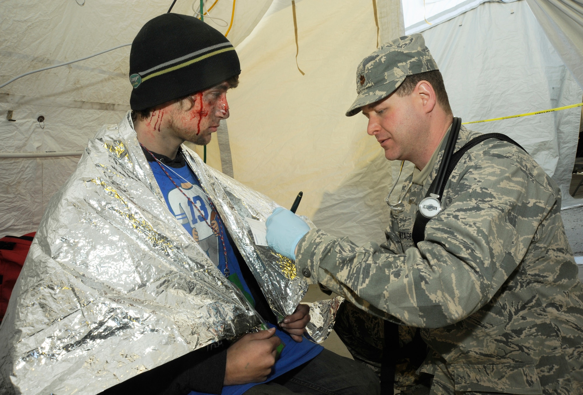 Air National Guard Maj. Damon Armitage, doctor assigned to the 142nd Fighter Wing, and member of the Oregon National Guard’s CBRNE Enhanced Response Force Package (CERFP), examines a simulated victim during the Vigilant Guard-Alaska 2014 exercise, near Joint Base Elmendorf-Richardson, Anchorage, Alaska, March 29, 2014. (U.S. Air National Guard photo by Tech. Sgt. John Hughel, 142nd Fighter Wing Public Affairs/Released)