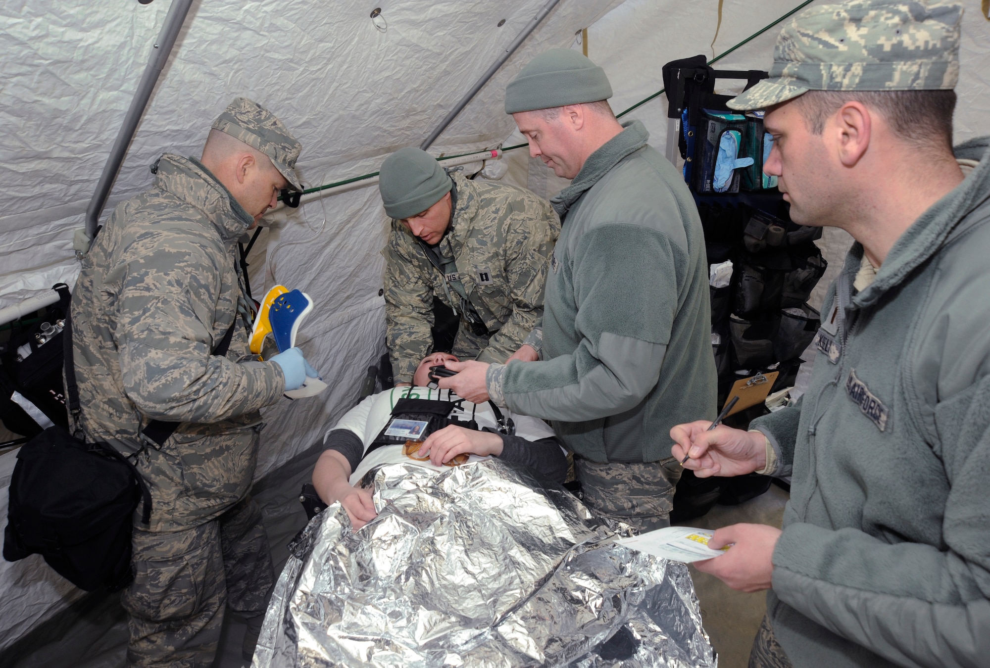 Air National Guard Members of the Oregon National Guard’s CBRNE Enhanced Response Force Package (CERFP), begin to treat a simulated victim during the Vigilant Guard-Alaska 2014 exercise, near Joint Base Elmendorf-Richardson, Anchorage, Alaska, March 29, 2014. (U.S. Air National Guard photo by Tech. Sgt. John Hughel, 142nd Fighter Wing Public Affairs/Released)
