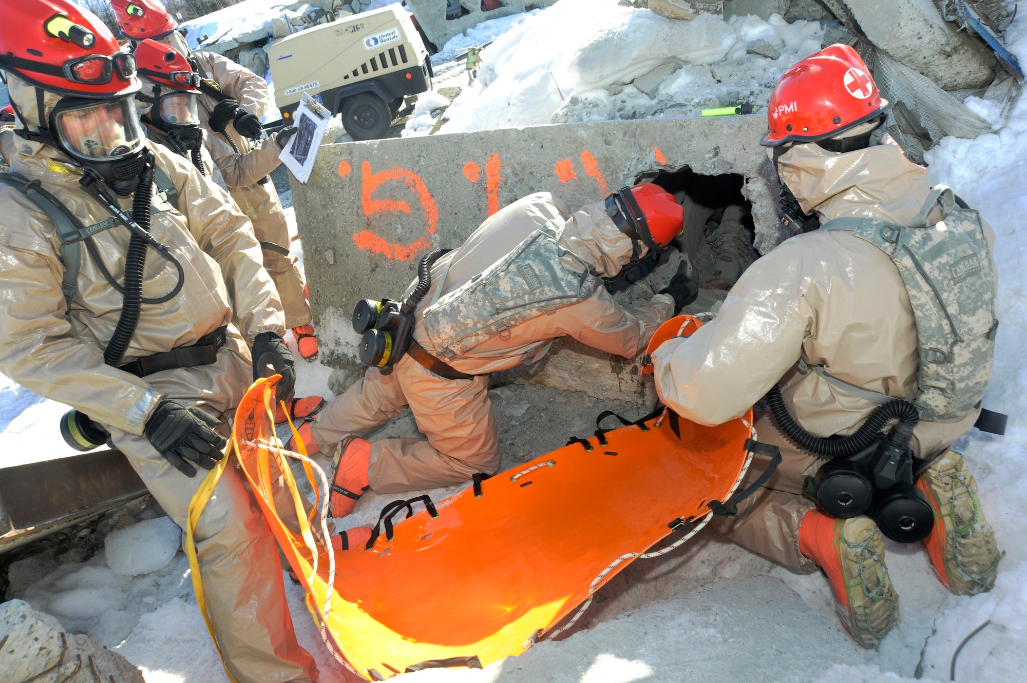 Members of the Oregon National Guard’s CBRNE Enhanced Response Force Package (CERFP), use a drill hammer as they attempt to free a simulated victim during the Vigilant Guard-Alaska 2014 exercise, near Joint Base Elmendorf-Richardson, Anchorage, Alaska, March 29, 2014. (U.S. Air National Guard photo by Tech. Sgt. John Hughel, 142nd Fighter Wing Public Affairs/Released)