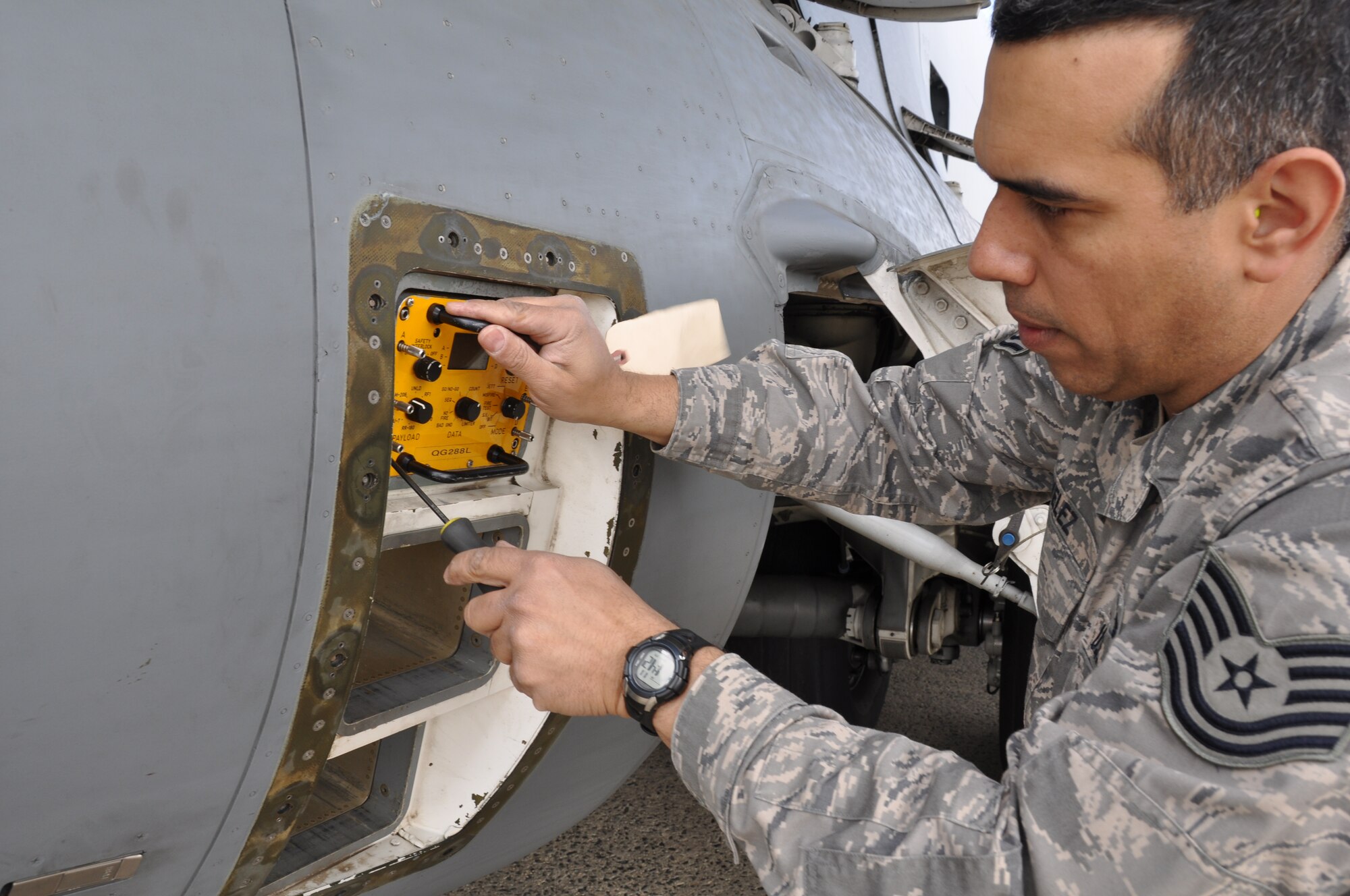 Tech Sgt. Dionisio Velez, 514th Aircraft Maintenance Squadron electronic warfare systems technician, installs an ALM288, a defensive system tester, to check countermeasure dispense systems on a C-17 Globemaster III aircraft here April 5 (U.S. Air Force photo Senior Airman Chelsea Smith).