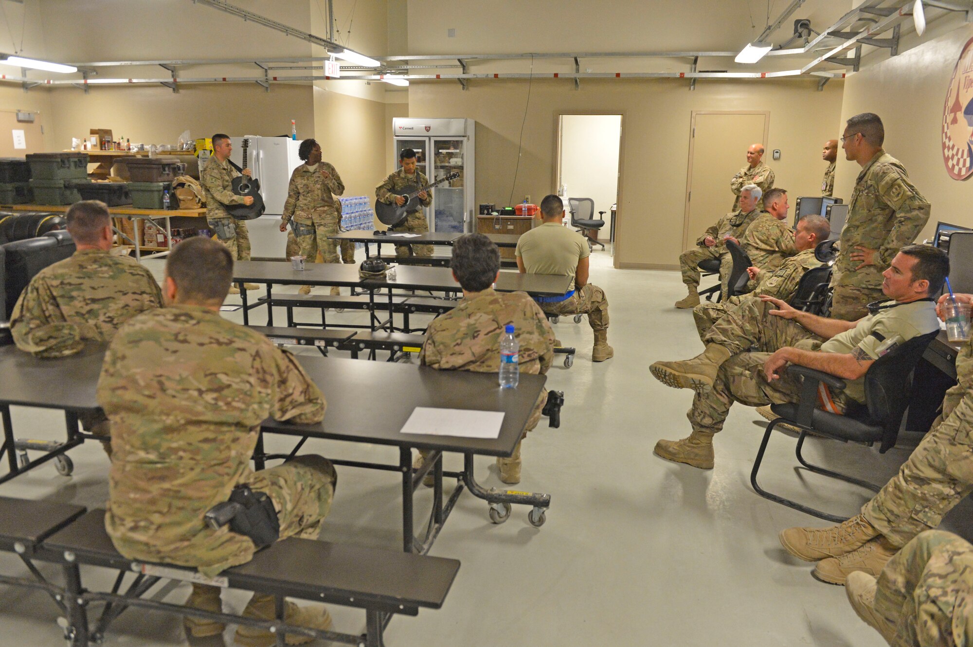 The U.S. Air Force Central Command Band, Hyper Sonic, plays for F-16 maintainers at Bagram Airfield, Afghanistan, March 31, 2014. The band played at various smaller venues around base, entertaining Service members not normally able to attend the larger shows.(U.S. Air Force photo by Senior Master Sgt. Gary J. Rihn/Released)
