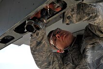 Senior Airman Shaun Mahathey, 421st Aircraft Maintenance Unit weapons load crew member, preps a platform on his team’s F-16 Fighting Falcon for a bomb during a quarterly weapons load crew competition at Osan Air Base, Republic of Korea, April 4, 2014. Mahathey and his team defeated load crews from the 25th and 36th Aircraft Maintenance Units to win the first load crew competition of 2014. (U.S. Air Force photo/Senior Airman Siuta B. Ika)