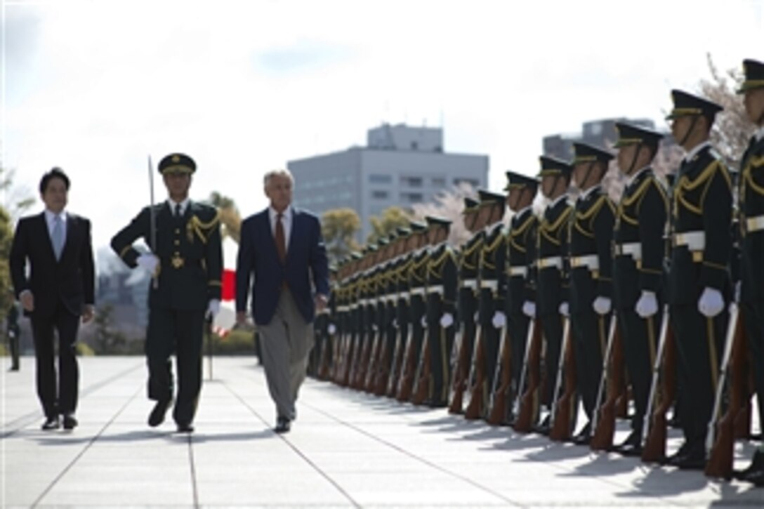 U.S. Defense Secretary Chuck Hagel reviews the troops during an arrival ceremony with Japanese Defense Minister Itsunori Onodera in Tokyo, April 6, 2014. 