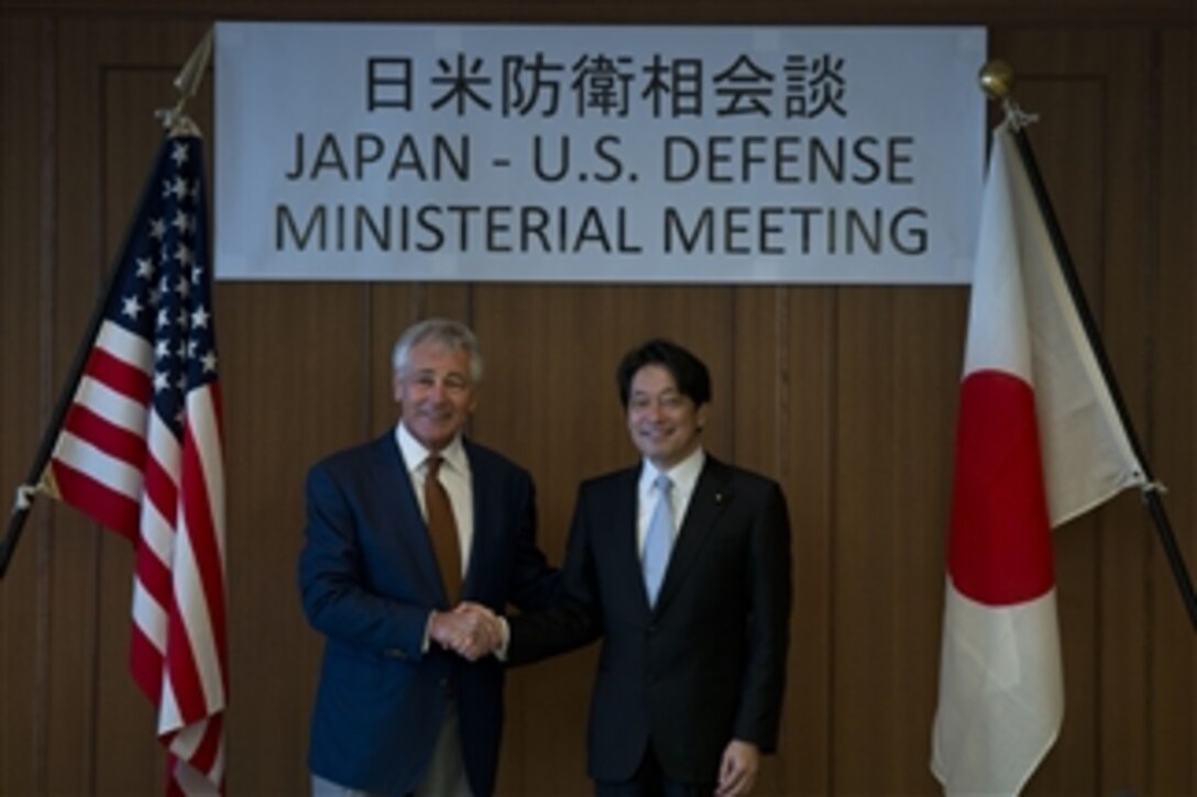 U.S. Defense Secretary Chuck Hagel and Japanese Defense Minister Itsunori Onodera pose for an official photo before a meeting in Tokyo, April 6, 2014. 