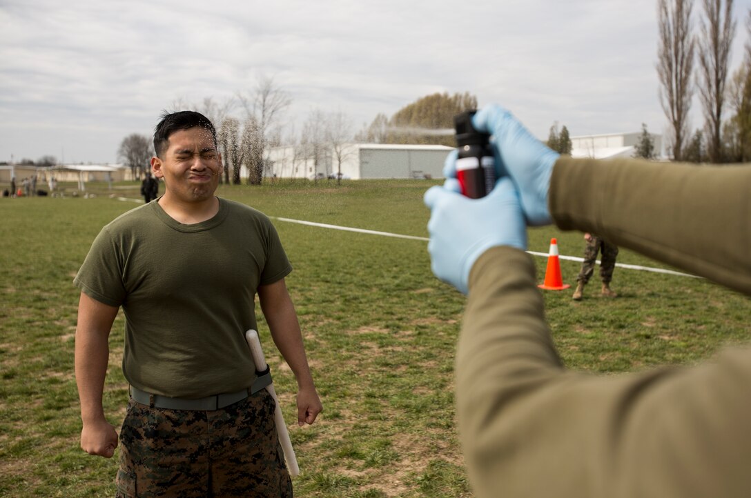 Corporal Peter Holguin, radio operator, 3rd Battalion, 8th Marine Regiment, 2nd Marine Division assigned to Black Sea Rotational Force 14, is exposed to oleoresin capsicum spray on Mihail Kogalniceanu Air Base, Romania, April 3, 2014. Marines and soldiers were directly exposed to the OC spray, then instructed to complete a course with stations which required them to execute different take down techniques on a simulated enemy combatant. Black Sea Rotational Force 14 is a contingent of Marines to maintain positive relations with partner nations, regional stability and increase interoperability while providing the capability for contingency response, as directed by U.S. European Command, in the Black Sea, Balkan and Caucasus regions of Eastern Europe. (Official Marine Corps photo by Staff Sgt. Tanner M. Iskra, 2nd Marine Division, Black Sea Rotational Force/ Released)