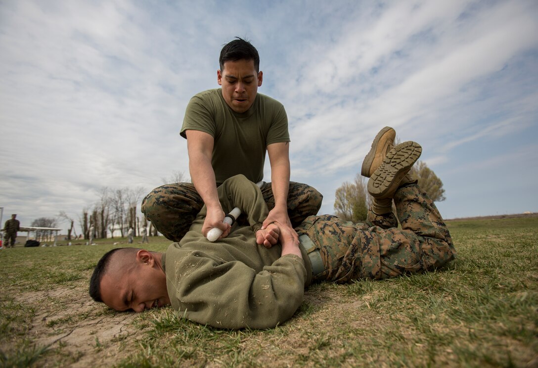 Corporal Peter Holguin, radio operator, 3rd Battalion, 8th Marine Regiment, 2nd Marine Division assigned to Black Sea Rotational Force 14, runs through a mechanical advantage-control holds course after being exposed to oleoresin capsicum spray on Mihail Kogalniceanu Air Base, Romania, April 3, 2014. Marines and soldiers were directly exposed to the OC spray, then instructed to complete a course with stations which required them to execute different take down techniques on a simulated enemy combatant. Black Sea Rotational Force 14 is a contingent of Marines to maintain positive relations with partner nations, regional stability and increase interoperability while providing the capability for contingency response, as directed by U.S. European Command, in the Black Sea, Balkan and Caucasus regions of Eastern Europe. (Official Marine Corps photo by Staff Sgt. Tanner M. Iskra, 2nd Marine Division, Black Sea Rotational Force/ Released)