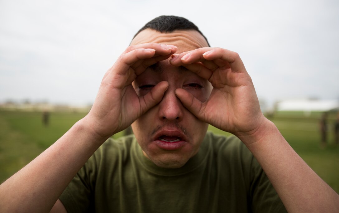 Corporal Jonathan Orozco, messman, Logistics Combat Element, assigned to Black Sea Rotational Force, reacts to the effect of being exposed to oleoresin capsicum spray after running through a mechanical advantage-control holds course on Mihail Kogalniceanu Air Base, Romania, April 3, 2014. Marines and soldiers were directly exposed to the OC spray, then instructed to complete a course with different stations which required them to execute different take down techniques on a simulated enemy combatant. Black Sea Rotational Force 14 is a contingent of Marines to maintain positive relations with partner nations, regional stability and increase interoperability while providing the capability for contingency response, as directed by U.S. European Command, in the Black Sea, Balkan and Caucasus regions of Eastern Europe. (Official Marine Corps photo by Staff Sgt. Tanner M. Iskra, 2nd Marine Division, Black Sea Rotational Force/ Released).