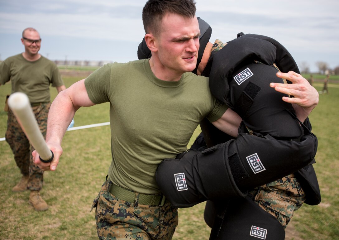 Lance Cpl. Travis Paskiewicz, chemical, biological, radiological, nuclear defense specialist, 3rd Battalion, 8th Marine Regiment, 2nd Marine Division assigned to Black Sea Rotational Force 14, runs through a mechanical advantage-control holds course after being exposed to oleoresin capsicum spray on Mihail Kogalniceanu Air Base, Romania, April 3, 2014. Marines and soldiers were directly exposed to the OC spray, then instructed to complete a course with stations which required them to execute different take down techniques on a simulated enemy combatant. Black Sea Rotational Force 14 is a contingent of Marines to maintain positive relations with partner nations, regional stability and increase interoperability while providing the capability for contingency response, as directed by U.S. European Command, in the Black Sea, Balkan and Caucasus regions of Eastern Europe. (Official Marine Corps photo by Staff Sgt. Tanner M. Iskra, 2nd Marine Division, Black Sea Rotational Force/ Released)