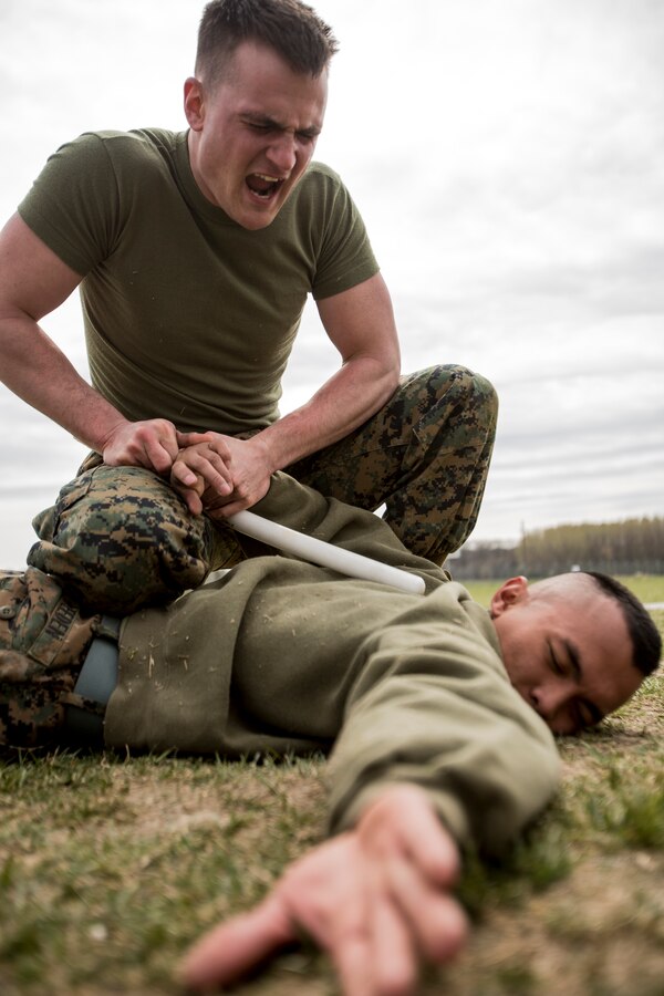 Lance Cpl. Travis Paskiewicz, chemical, biological, radiological, nuclear defense specialist, 3rd Battalion, 8th Marine Regiment, 2nd Marine Division assigned to Black Sea Rotational Force 14, executes a mechanical advantage-control holds course after being exposed to oleoresin capsicum spray on Mihail Kogalniceanu Air Base, Romania, April 3, 2014. Marines and soldiers were directly exposed to the OC spray, then instructed to complete a course with stations which required them to execute different take down techniques on a simulated enemy combatant. Black Sea Rotational Force 14 is a contingent of Marines to maintain positive relations with partner nations, regional stability and increase interoperability while providing the capability for contingency response, as directed by U.S. European Command, in the Black Sea, Balkan and Caucasus regions of Eastern Europe. (Official Marine Corps photo by Staff Sgt. Tanner M. Iskra, 2nd Marine Division, Black Sea Rotational Force/ Released)