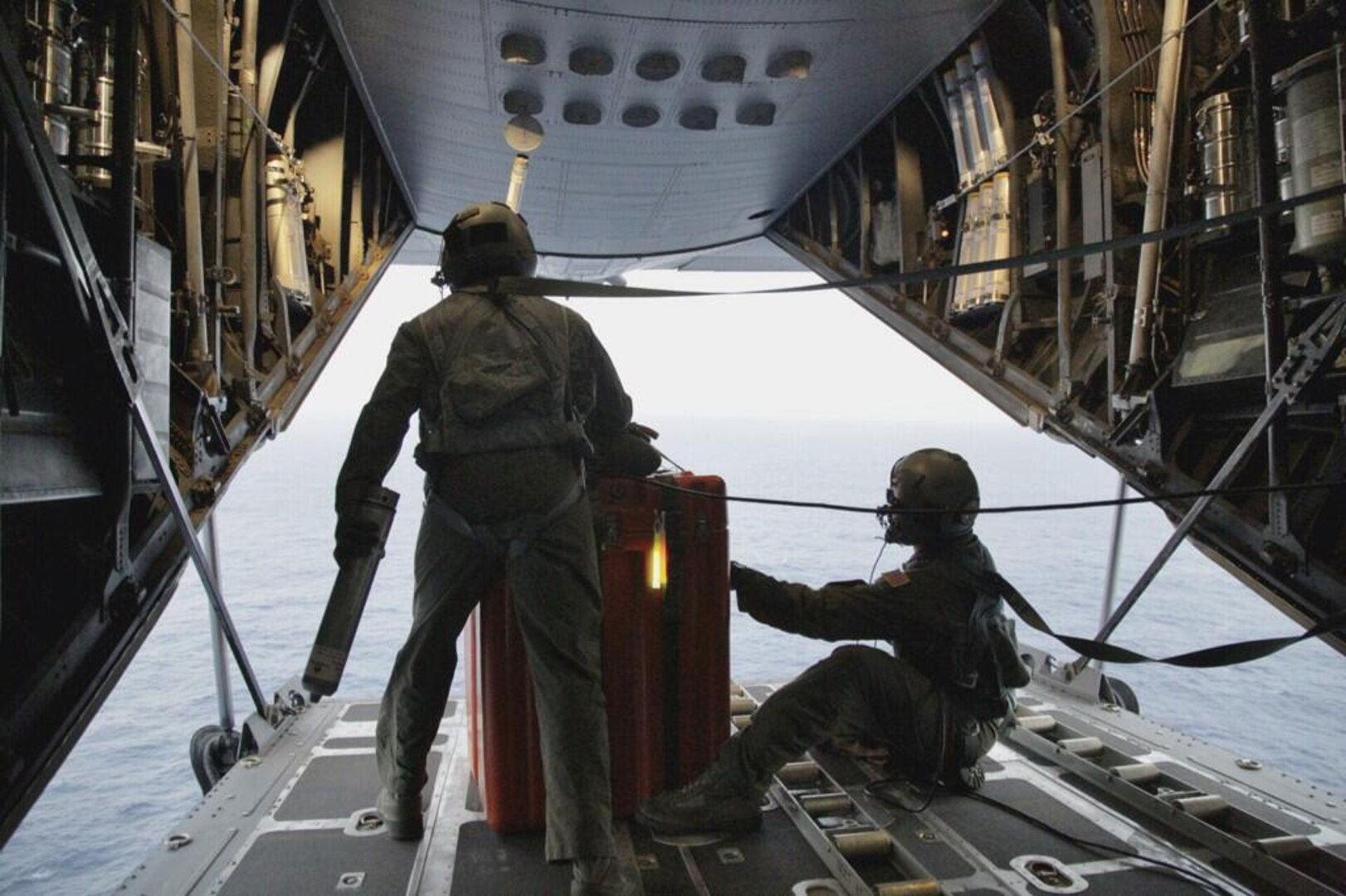 Pararescuemen from the 129th Rescue Wing, Moffett Federal Airfield, Calif., prepare April 3, 2014, to jump from an MC-130P Combat Shadow aircraft with Zodiac raft and other lifesaving gear.