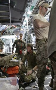 Crew from the 129th Rescue Wing in  California conduct a briefing April 3, 2014, before four pararescuemen jump into the Pacific Ocean to rescue a family stranded at sea with a critically ill infant.