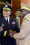 Maj. Gen. David Sprynczynatyk, left, North Dakota adjutant general, and Brig. Gen. Abalo Kadangha, chief of defense staff of the Togolese Armed Forces, shake hands in Lome, Togo, on April 4, 2014.

