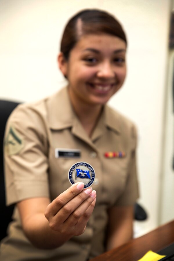 U.S. Marine Corps Lance Cpl. Cynthia Luna, awards chief, 12th Marine Corps District (MCD), is awarded a challenge coin from the Honorable Jessica Wright, the Under Secretary of Defense for Personnel and Readiness aboard Marine Corps Recruit Depot San Diego, April 3, 2014. Wright was visiting to familiarize herself with the Marines and Recruiting Stations of the 12th MCD. (U.S. Marine Corps Photo by Cpl. Catie Massey/Released)
