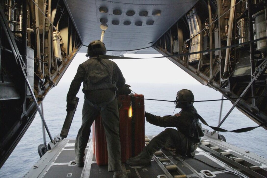 Pararescuemen from the 129th Rescue Wing, Moffett Federal Airfield, Calif., prepare April 3, 2014, to jump from an MC-130P Combat Shadow aircraft with Zodiac raft and other lifesaving gear. (U.S. Air Force photo/Airman 1st Class Julia Bates)