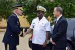 Maj. Gen. David Sprynczynatyk, North Dakota adjutant general, shakes hands with Rear Admiral Denis H. Gbessemahlem, chief of the defense staff, Beninese Armed Forces, as Michael Raynor, U.S. ambassador to Benin, looks on, in Cotonou, Benin on April 3, 2014. The exchange followed a ceremony in which the North Dakota National Guard formalized its association with the Republic of Benin under the auspices of the National Guard Bureau’s State Partnership Program. 