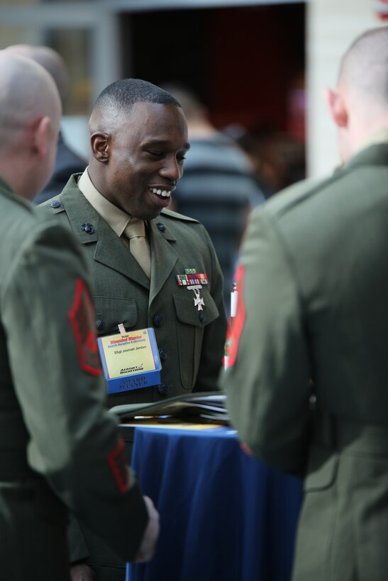 Staff Sgt. Joshiah Jordan, recipient of the Wounded Warrior Regiment Leadership Award, talks to a few other Marines during the Wounded Warrior Awards Reception and Ceremony at the National Museum of the Marine Corps on April 3, 2014. Jordan was recognized for his ability to ensure that all the Marines in his charge are given the best opportunities to move forward in their careers and ensuring efficiency in the work place. 