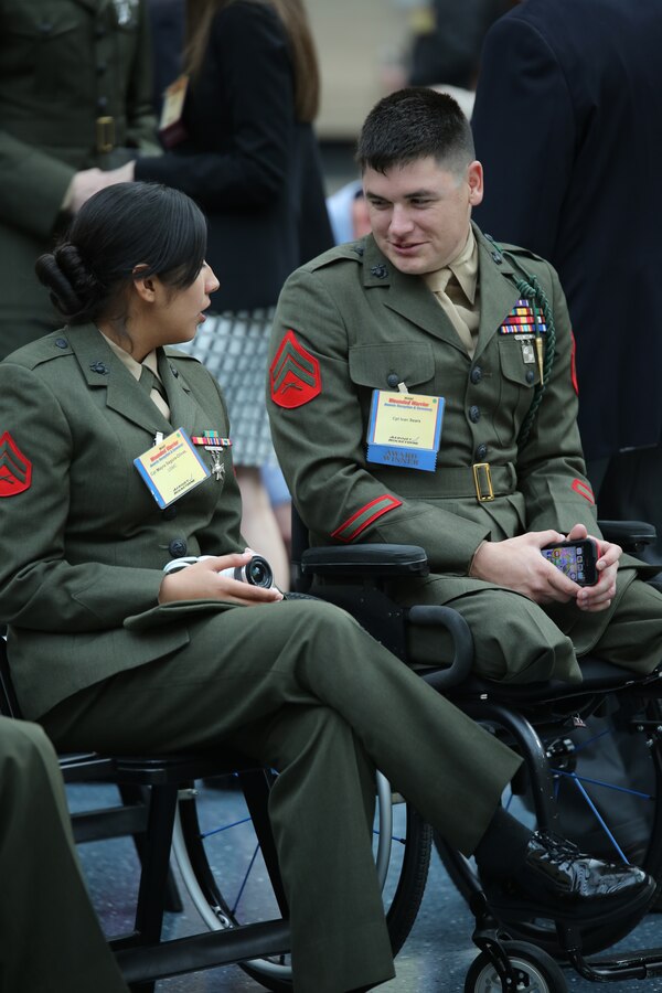 Cpl. Ivan Sears, recipient of the Wounded Warrior Wounded, Ill or Injured Service Member Award, talks to a fellow Marine during the Wounded Warrior Awards Reception and Ceremony at the National Museum of the Marine Corps on April 3, 2014. Sears was recognized for his optimism and for his actions as an athlete representing the Wounded Warrior Regiment and the Marine Corps during several sporting events. 