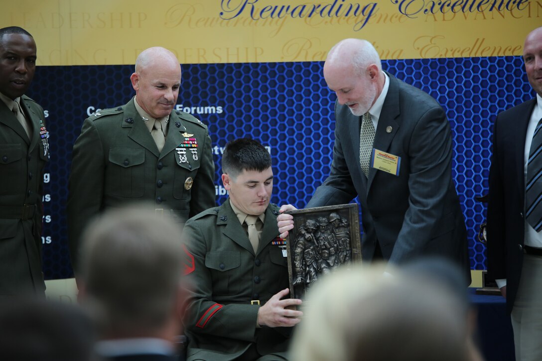Cpl. Ivan Sears, a staff member of the Family Reception section of the Wounded Warrior-East Bn., San Antonio, Texas Detachment, receives the Wounded Warrior Wounded, Ill or Injured Service Member Award during the Wounded Warrior Awards Reception and Ceremony at the National Museum of the Marine Corps on April 3, 2014. Sears was recognized for his optimism and for his actions as an athlete representing the Wounded Warrior Regiment and the Marine Corps during several sporting events. 
