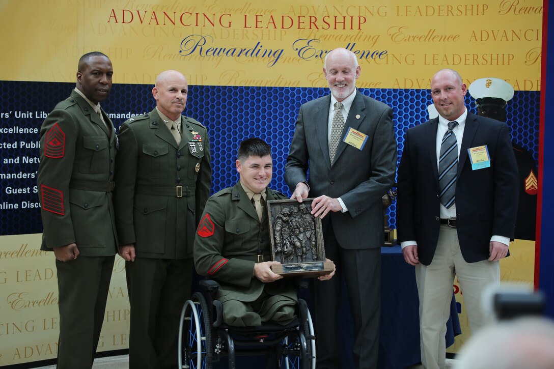Cpl. Ivan Sears, a staff member of the Family Reception section of the Wounded Warrior-East Bn., San Antonio, Texas Detachment, receives the Wounded Warrior Wounded, Ill or Injured Service Member Award during the Wounded Warrior Awards Reception and Ceremony at the National Museum of the Marine Corps on April 3, 2014. Sears was recognized for his optimism and for his actions as an athlete representing the Wounded Warrior Regiment and the Marine Corps during several sporting events. 